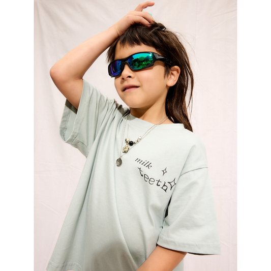 Mint | A child is wearing a mint Milk Teeth tee with reflective sunglasses and a necklace