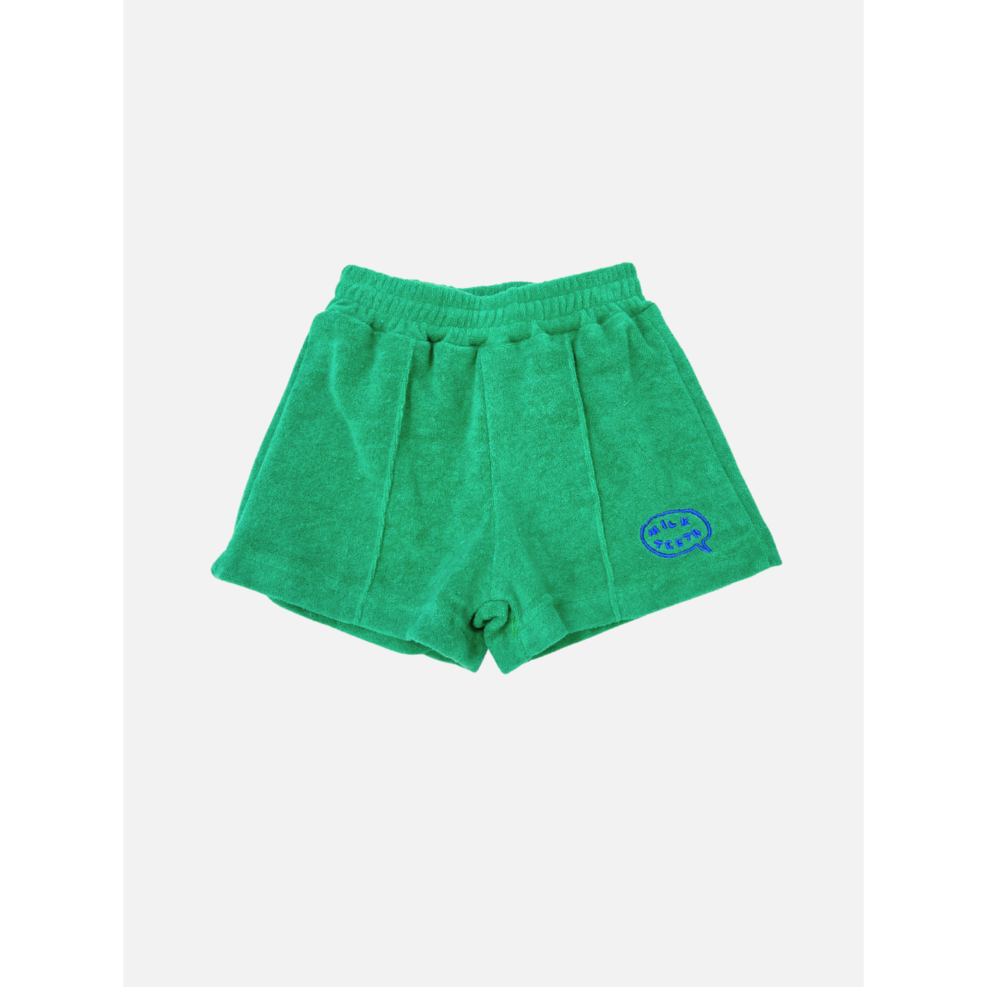 Green | EVERYDAY TERRY SHORTS in green cotton terry, featuring an elastic waist and a blue embroidered logo patch on the lower right leg, shown against a plain white background.