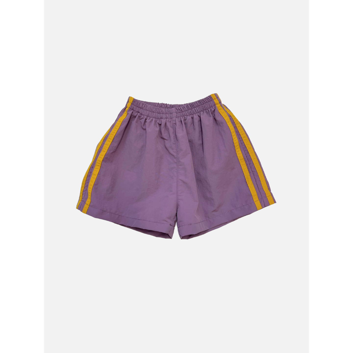 Purple | SPRINTER SHORTS in purple, featuring yellow side stripes, an elasticated waist, and a relaxed fit. Made from performance fabric and shown on a plain white background.
