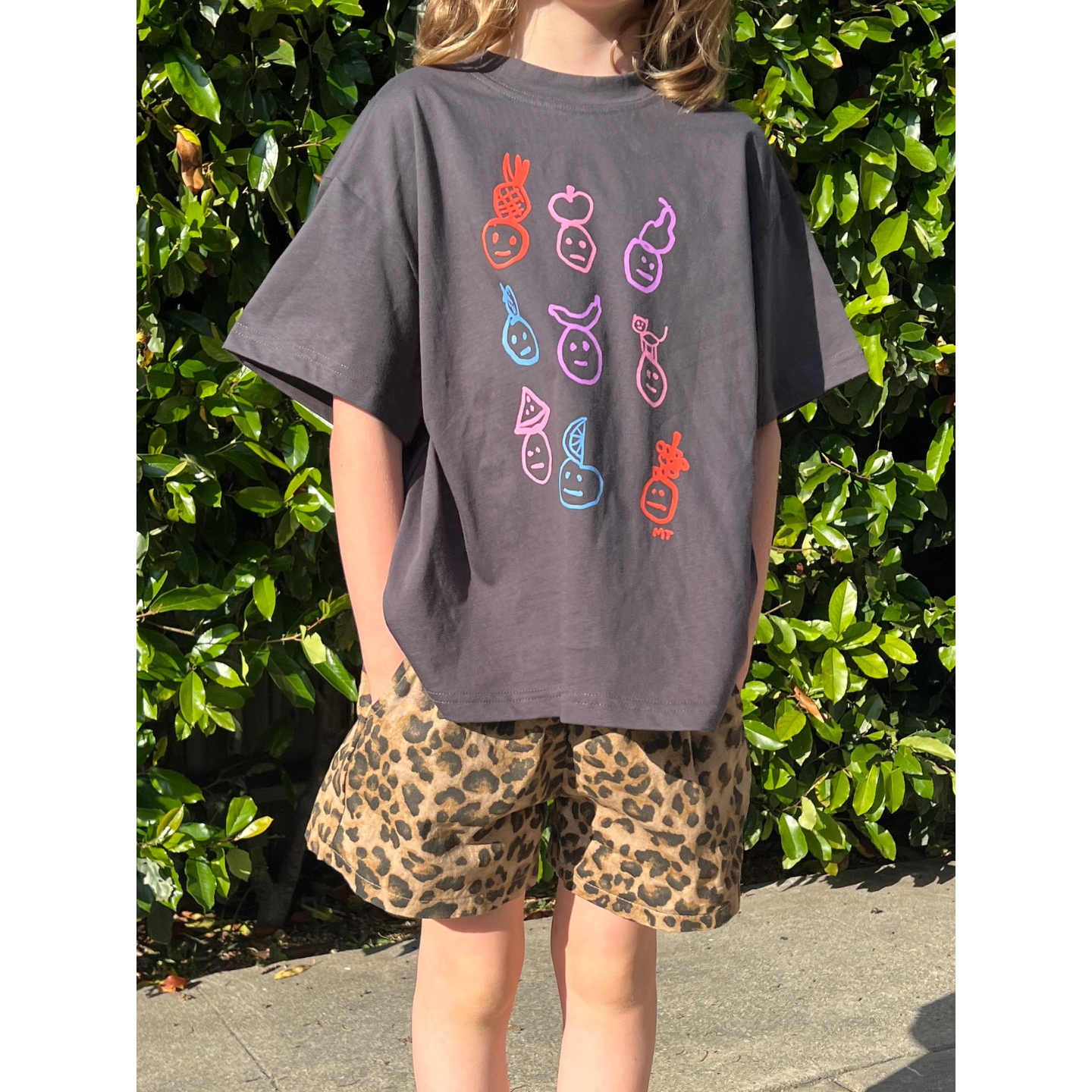 Charcoal | A child is wearing a charcoal fruit face tee