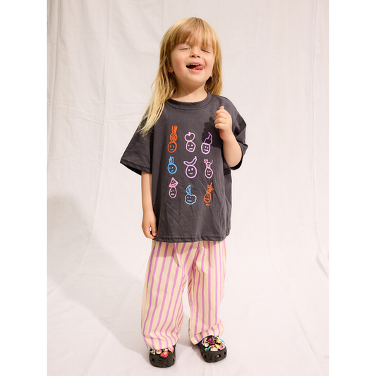 Charcoal | A child is wearing a Charcoal Fruit face tee with Pine Pants and black crocs