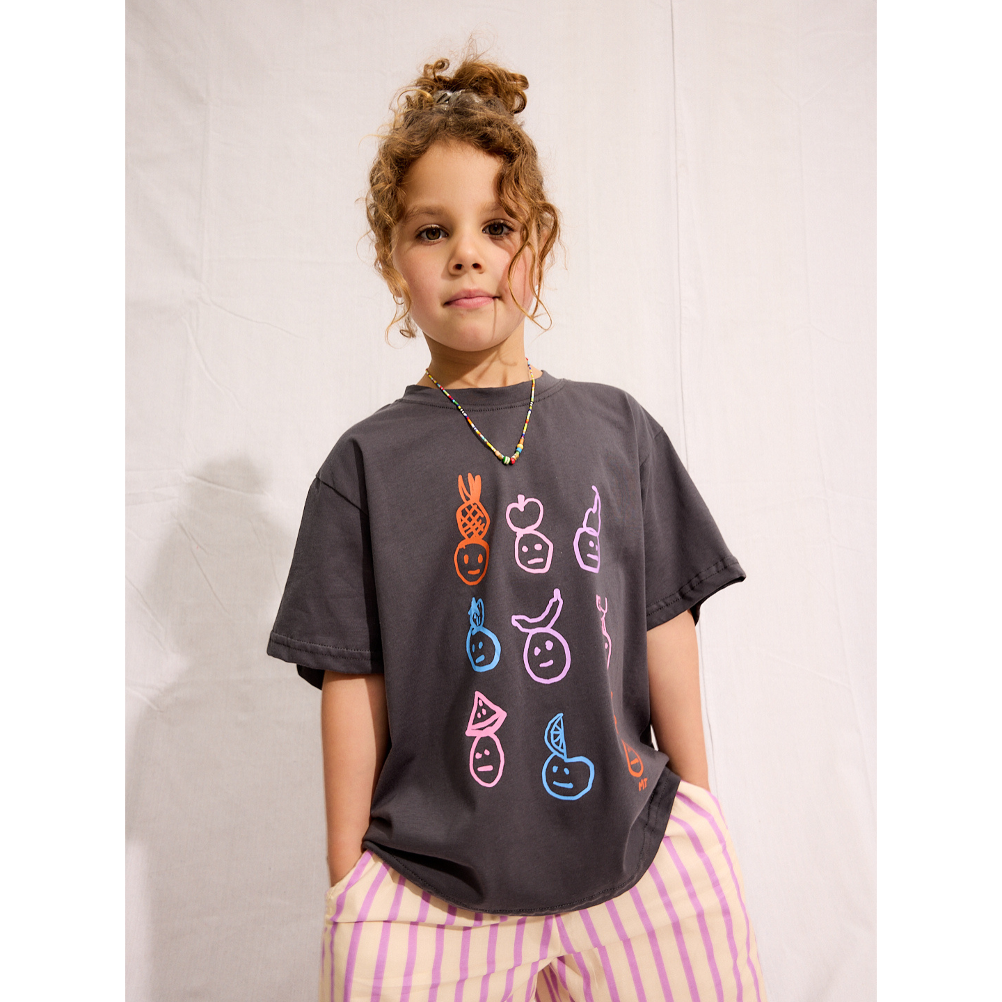 Charcoal | A child is wearing a Charcoal Fruit face tee with Pine Pants