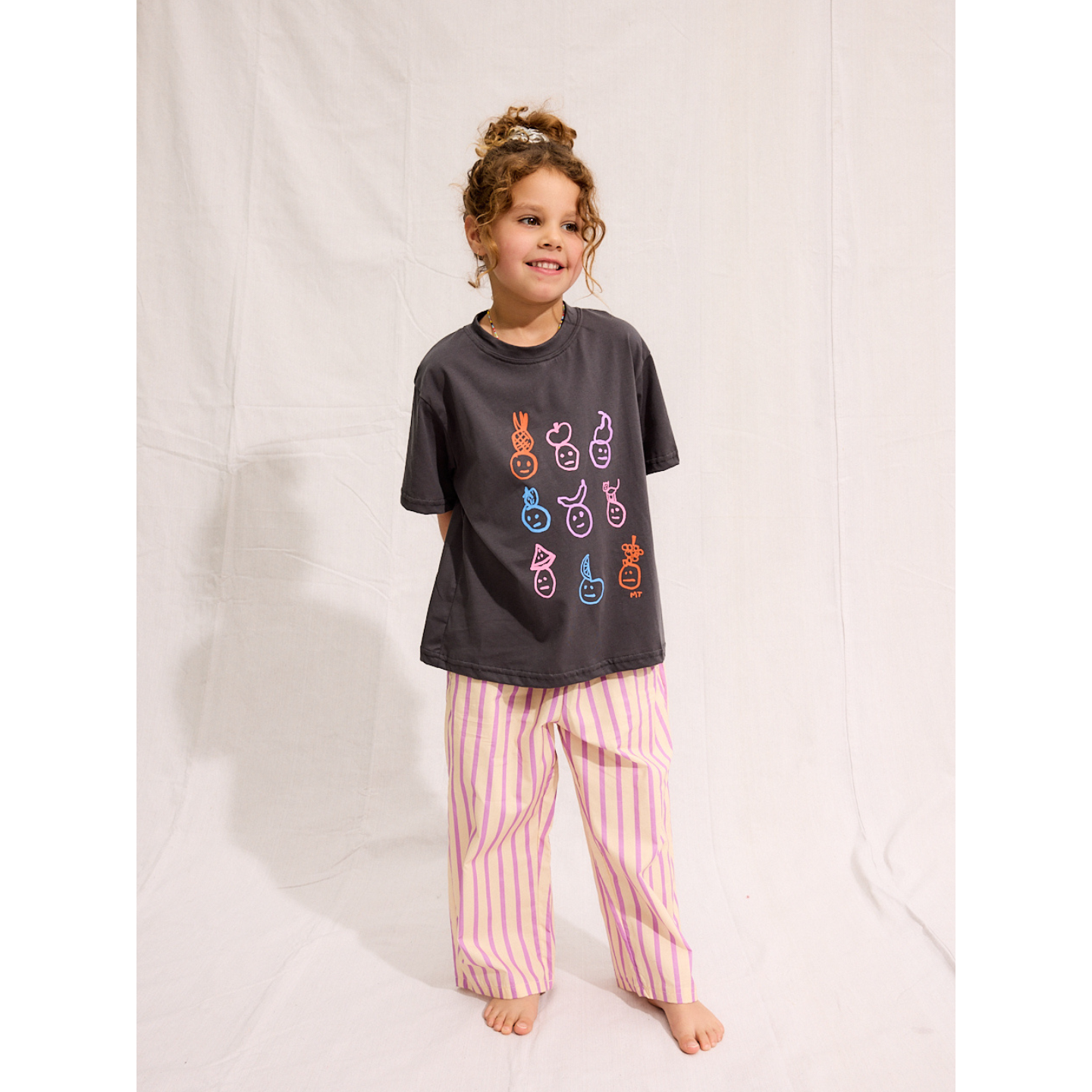 Charcoal | A child is wearing a Charcoal Fruit face tee with Pine Pants