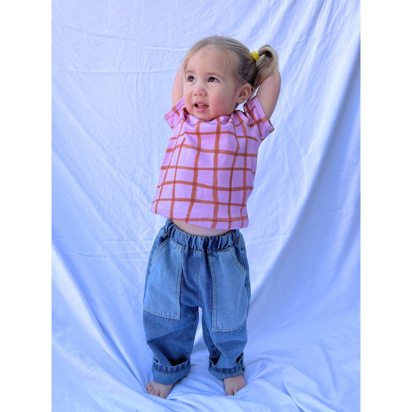 Medium Wash | A child is wearing double trouble jeans with a checkered tee