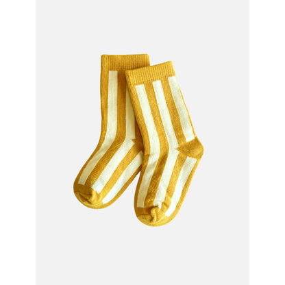 Marigold | A pair of comfy STRIPE SOCK in marigold with vertical white stripes, crafted from stretchy cotton, on a plain white background.