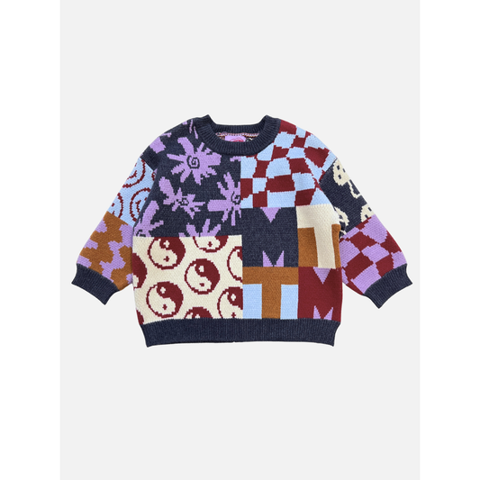 The EVERYTHING SWEATER is a soft knit featuring a patchwork design with yin-yang symbols, flowers, wavy checkers, and geometric shapes in purple, red, cream, blue, and brown tones.